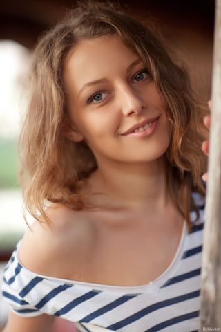 Девка в полосатом платье на улице светит для друга небольшими сиськами
